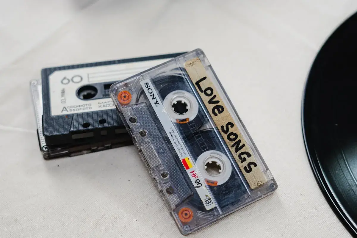 Cassette tapes and headphones on a desk — owning a copy of music still comes with a license